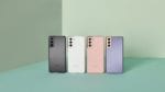 Four Samsung Galaxy smartphones in different colors – gray, white, pink, and purple – arranged side by side on a mint green background, showcasing the latest smartphone models and color options available from the brand.