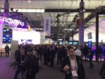 Wide interior view of a crowded technology trade show floor with large Huawei and Galaxy exhibits showcasing 5G and mobile devices, demonstrating the promotion and display of cutting-edge wireless networking and smartphone technologies at major industry events.