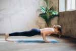 Woman in Black Tank Top and Black Leggings Doing Yoga